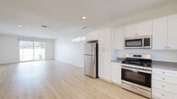 Located at 43808 Vintage St in Lancaster, CA, this single-story 2-bedroom, 2-bathroom home offers a clean, modern aesthetic throughout. Light wood-style flooring flows seamlessly across all rooms, complementing the bright white walls and recessed lighting that create a fresh, airy atmosphere.

The open-concept kitchen and living area serves as the heart of the home. The kitchen is well-appointed with white shaker cabinetry, gray countertops, a full suite of stainless steel appliances including a gas range, built-in microwave, refrigerator, and dishwasher, along with a dedicated sink with window view. The space opens naturally into a generous living area bathed in natural light from clerestory windows.

Both bedrooms are comfortably sized with large windows inviting abundant natural light. The primary bedroom features sliding glass doors leading directly to the private patio and yard area. Each bedroom benefits from dedicated closet space, with three closets total throughout the home.

The two bathrooms maintain the home's clean design palette with white cabinetry and vanities. One bathroom features a tub-shower combo with white subway tile surround, while the second offers a walk-in glass-enclosed shower. A dedicated laundry area adds everyday convenience. The outdoor patio provides a private retreat with a lawn area, completing this well-designed home.
