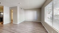 Located at 3202 N Country Club Rd in Tucson, Arizona, this single-floor unit offers a practical and efficiently designed layout. Light wood-style flooring runs continuously throughout the space, lending a cohesive and clean aesthetic to every room.

The open-concept kitchen and living area form the heart of the unit. The living area features neutral beige walls, a textured ceiling, and a ceiling fan with integrated lighting, creating a comfortable and functional space. Natural light enters through slatted blinds, brightening the room. The kitchen is well-appointed with gray cabinetry, light countertops, a single-basin sink, and black appliances including a range, dishwasher, and refrigerator. A range hood is positioned above the stove, and ample cabinet storage is provided both above and below the counter.

A separate bedroom area offers a quiet retreat, with continued neutral tones, a window with blinds, and consistent flooring. The bathroom is straightforward and functional, featuring a tub-shower combination, a toilet, a vanity with storage, and a ceiling-mounted light fixture. The overall design of the unit prioritizes clean lines, neutral finishes, and practical use of space, making it a well-organized and easy-to-maintain residence in the heart of Tucson.