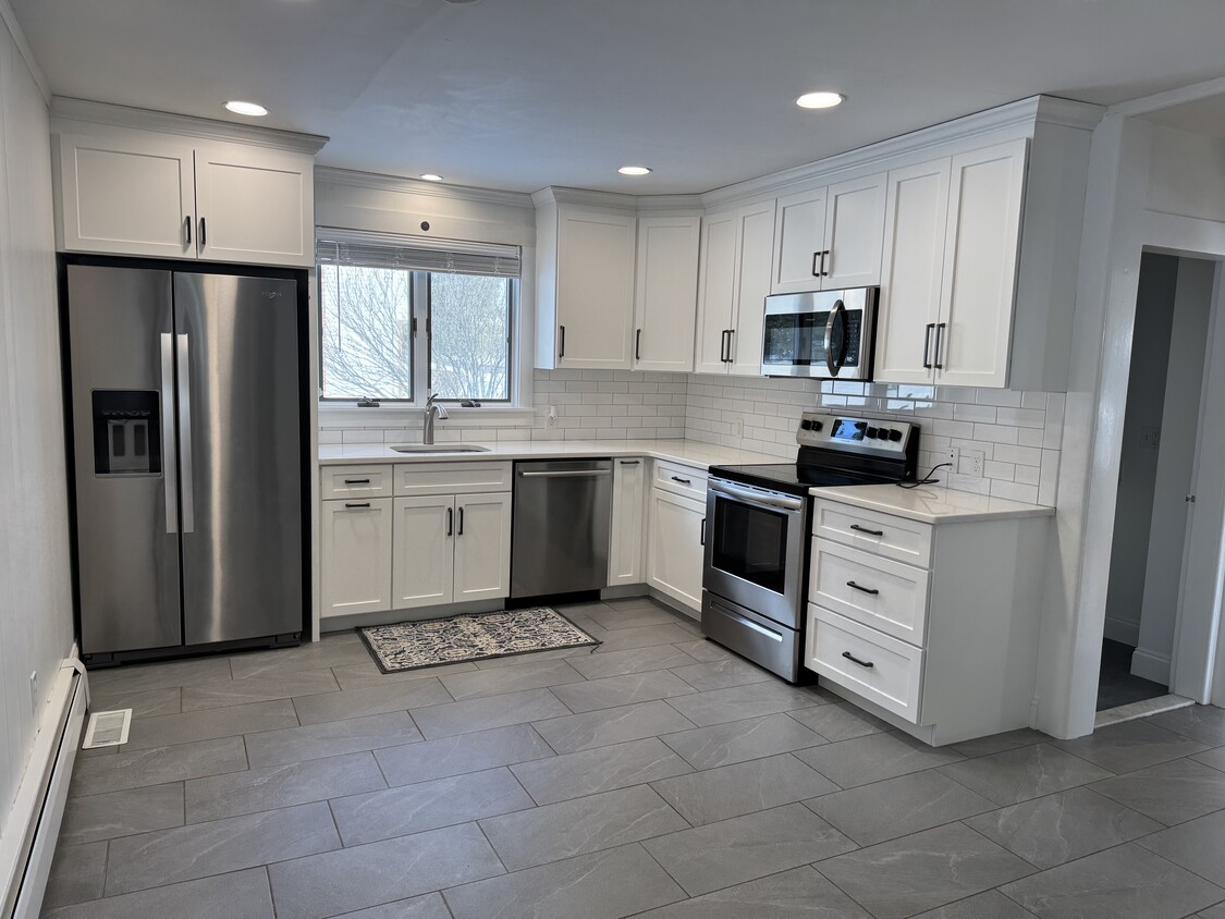 Kitchen with Quartz counters and stainless steel appliances - 32 Raynor St