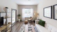 This single-floor residence offers a thoughtfully designed layout with a contemporary aesthetic rooted in neutral tones and clean finishes. The living room serves as a welcoming central space, featuring wood-look plank flooring, large windows with sheer curtains that invite generous natural light, and a ceiling fan for added comfort. A sliding glass door provides additional brightness and outdoor connectivity.

The kitchen is well-equipped with white shaker cabinetry, granite-style countertops, a white subway tile backsplash, and a full suite of stainless steel appliances, including a side-by-side refrigerator with ice maker, electric range, built-in microwave, and dishwasher. A large pantry with paneled gray doors adds notable storage capacity.

Multiple bedrooms continue the neutral palette, each featuring plush carpet, ceiling fans, and generously sized windows framing views of lush greenery. The rooms offer ample space for comfortable furnishings and personal storage.

The bathrooms are finished with wood-look flooring, white shaker vanity cabinetry, granite countertops, and large mirrors. One bathroom features a soaking tub with subway tile surround, while another includes a walk-in shower. Both bathrooms provide access to walk-in closets, enhancing overall functionality throughout the residence.
