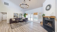 Located at 7747 Greenback Ln in Citrus Heights, CA, this single-floor commercial space offers a thoughtfully designed layout across four distinct areas. The standout feature is the expansive great room, distinguished by dramatically high vaulted ceilings, light wood-look flooring, and a striking black-tiled fireplace. A statement wrought-iron wagon wheel chandelier anchors the space, while large French doors flood the room with natural light and open directly to an outdoor pool area, creating a seamless indoor-outdoor connection. A welcoming entry area also benefits from the soaring ceilings, featuring a secondary fireplace, a front-facing door with a display window, and warm natural light through bamboo-shaded windows. The well-appointed kitchen includes crisp white cabinetry, granite countertops, stainless steel appliances, light wood-look flooring, and a bamboo-shaded window. A dedicated fitness area is equipped with an array of exercise machines, making it suitable for a wellness-oriented use. The ADA-accessible restroom is fully tiled in a classic grey and teal palette, complete with grab bars and commercial-grade fixtures. Together, these spaces create a functional and inviting environment well-suited for a variety of professional or wellness-focused uses.