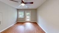 Located at 1030 Atlas Rd in Columbia, SC, this single-story, one-bedroom, one-bathroom home offers a well-designed and functional layout. Throughout the home, warm honey-toned hardwood-style flooring and neutral gray-beige walls create a cohesive, inviting atmosphere. Ceiling fans are present in multiple rooms, providing both comfort and style.

The combined kitchen and living area serves as the heart of the home. The kitchen is outfitted with crisp white shaker-style cabinetry, granite-look countertops, and a full suite of stainless steel appliances, including a refrigerator, electric range, and dishwasher. The living area benefits from natural light streaming through a large glass-paned entry door and an adjacent window, offering pleasant outdoor views of the surrounding greenery.

The spacious primary bedroom features warm flooring, a ceiling fan with light fixture, a window with outdoor views, and a closet with paneled doors, providing ample storage. The bathroom is designed with accessibility in mind, featuring grab bars near the toilet and shower area, a vanity with a countertop sink, and wood-look vinyl flooring. The tub/shower combination and open layout make it both practical and comfortable. This home combines functional design with clean, modern finishes throughout.