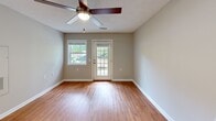 Located at 1030 Atlas Rd in Columbia, SC, this single-story, one-bedroom, one-bathroom home offers a well-designed and functional layout. Throughout the home, warm honey-toned hardwood-style flooring and neutral gray-beige walls create a cohesive, inviting atmosphere. Ceiling fans are present in multiple rooms, providing both comfort and style.

The combined kitchen and living area serves as the heart of the home. The kitchen is outfitted with crisp white shaker-style cabinetry, granite-look countertops, and a full suite of stainless steel appliances, including a refrigerator, electric range, and dishwasher. The living area benefits from natural light streaming through a large glass-paned entry door and an adjacent window, offering pleasant outdoor views of the surrounding greenery.

The spacious primary bedroom features warm flooring, a ceiling fan with light fixture, a window with outdoor views, and a closet with paneled doors, providing ample storage. The bathroom is designed with accessibility in mind, featuring grab bars near the toilet and shower area, a vanity with a countertop sink, and wood-look vinyl flooring. The tub/shower combination and open layout make it both practical and comfortable. This home combines functional design with clean, modern finishes throughout.