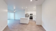 Located at 2089 Heritage Key Blvd in Kissimmee, FL, this well-designed one-bedroom, one-bathroom residence offers a clean, modern aesthetic throughout its efficiently organized single-floor layout. Light-toned wood-style flooring flows seamlessly across the entire space, complementing the bright white walls and creating a cohesive, airy feel.

The open-concept kitchen and living area serves as the heart of the home. The kitchen is outfitted with crisp white shaker-style cabinetry, a full suite of stainless steel appliances including a refrigerator, range, and built-in microwave, and a central island with a white countertop that provides additional prep and seating space. Recessed lighting illuminates the kitchen, while a ceiling fan keeps the adjacent living area comfortable.

The bedroom is a comfortable, well-proportioned retreat featuring a ceiling fan, a large window overlooking greenery for ample natural light, and direct access to a walk-in closet equipped with wire shelving for organized storage. The bathroom includes a full bathtub with shower, white vanity cabinetry, and wood-style flooring consistent with the rest of the home.

A dedicated laundry room with a full-size washer and dryer adds everyday convenience, rounding out this functional and neatly presented Kissimmee residence.
