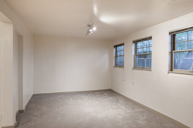 Carpeted living room with four southern exposure windows. - 1029 Summit Ave E