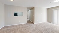 Located at 116 Northwoods Dr in Seneca, SC, this single-floor, 2-bedroom, 2-bathroom home offers a well-organized layout designed for comfortable everyday living. The open-concept living and dining area is finished with warm neutral-toned walls and plush carpet, creating an inviting atmosphere bathed in natural light. A bold dark front door serves as a striking entry point into the space. The kitchen connects seamlessly to the living area via a pass-through window, and features white shaker-style cabinetry, granite-look countertops, a stainless steel sink, dishwasher, and range, all set over wood-look flooring. The primary bedroom is generously sized, with carpet flooring, natural light, and direct access to a private bathroom equipped with a tub-shower combo and a vanity with white cabinetry. The second bedroom also offers carpet flooring, a window for natural light, and a closet with sliding panel doors. Four closets throughout the home provide ample storage, including a spacious walk-in closet with wire shelving. Both bathrooms are finished with wood-look tile flooring and tub-shower combinations. A dedicated laundry area with washer and dryer hookups adds everyday convenience, completing this functional and well-appointed home.