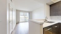This contemporary 1-bedroom apartment in Marina Del Rey offers 490 square feet of efficiently designed living space. The unit features an open-concept layout, maximizing the use of available area. The living room is highlighted by a distinctive corner window, allowing ample natural light to flood the space. Wood-look flooring runs throughout, adding warmth and continuity.

The kitchen boasts modern amenities, including stainless steel appliances and sleek dark wood cabinetry, creating a striking contrast against white countertops and backsplash. The bathroom continues the modern aesthetic with a clean white palette, featuring a combination tub-shower and a floating vanity.

The bedroom, measuring 110 square feet, includes a sliding glass door leading to a private balcony, offering outdoor space and city views. Built-in closets provide ample storage. Throughout the apartment, recessed lighting and track fixtures enhance the contemporary ambiance.

Located at 13603 Marina Pointe Dr, this unit (C517) combines urban convenience with a touch of coastal living. The efficient design and modern finishes make this apartment an ideal space for those seeking a stylish and functional home in the heart of Marina Del Rey.