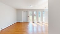 Located at 8 Wilsonview Ave in Guelph, Ontario, this well-appointed one-bedroom, one-bathroom unit offers a functional and comfortable single-floor layout. The living room is a standout feature, bathed in natural light streaming through a row of tall, narrow windows that frame views of the surrounding greenery. Warm hardwood flooring extends throughout the living and bedroom areas, creating a cohesive and inviting atmosphere. The bedroom is a cozy, private space with the same hardwood flooring and clean neutral walls, offering a calm retreat. The kitchen is efficiently designed with rich dark-toned cabinetry, light countertops, a decorative tile backsplash with mosaic accent detailing, and a full suite of stainless steel appliances including an electric range, built-in microwave, and dishwasher. Light tile flooring completes the kitchen's clean, modern look. The bathroom features a full soaker tub and shower combo with white tile surround, light tile flooring, and classic chrome fixtures, maintaining a clean and practical aesthetic throughout. The unit's thoughtful layout makes excellent use of its space, providing all essential rooms in a compact and efficient footprint ideal for comfortable everyday living.