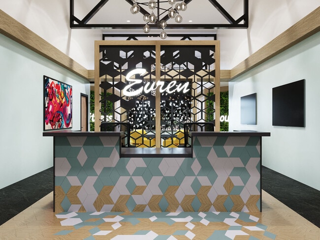 Welcoming lobby with front desk and modern finishes. - Evren Apartments of Lees Summit