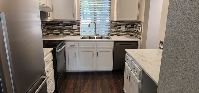 Kitchen with stainless steel appliances - 1411 E Hays St