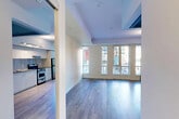 This 400 square foot apartment, located at 27 Phipps St in Toronto, exemplifies efficient urban living. The single-floor layout comprises a kitchen, bathroom, and open living area, maximizing functionality within a compact space. The modern kitchen boasts sleek white cabinetry, stainless steel appliances, and granite countertops, creating a streamlined cooking environment. Large floor-to-ceiling windows flood the space with natural light and provide stunning city views, enhancing the sense of openness. The bathroom features neutral tiling, a combination tub-shower, and a floating vanity, maintaining a clean, contemporary aesthetic. Throughout the apartment, light-toned hardwood flooring unifies the space and contributes to its bright, airy ambiance. The open-concept design allows for flexible furniture arrangements, making the most of the available square footage. Despite its modest size, this apartment offers a comfortable and stylish living solution in the heart of Toronto.