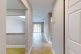 Located at 6700 Nova Dr in Davie, FL, this single-floor, 2-bedroom, 2-bathroom residence offers a well-organized layout designed for comfortable living. Light-toned tile flooring flows throughout the main areas, beginning with a welcoming hallway that connects the kitchen, living spaces, and bedrooms. The open-concept living and dining room is bright and airy, benefiting from natural light streaming through a sliding glass door that opens onto a private balcony with outdoor views. The kitchen features white cabinetry, granite-style countertops, a pass-through window to the living area, and stainless steel appliances including a dishwasher and range. Both bedrooms are carpeted and receive natural light through windows with outdoor greenery views. The primary bedroom is generously sized and includes dedicated closet space. The two bathrooms are finished with stone-tile surrounds and granite-topped white vanities; one features a soaking tub with a tiled shower combo, while the other offers a glass-enclosed walk-in shower. Additional spaces include a laundry area, utility room, and two closets, rounding out this efficiently designed and well-appointed residence in Davie.
