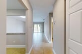 Located at 6700 Nova Dr in Davie, FL, this single-floor, 2-bedroom, 2-bathroom residence offers a well-organized layout designed for comfortable living. Light-toned tile flooring flows throughout the main areas, beginning with a welcoming hallway that connects the kitchen, living spaces, and bedrooms. The open-concept living and dining room is bright and airy, benefiting from natural light streaming through a sliding glass door that opens onto a private balcony with outdoor views. The kitchen features white cabinetry, granite-style countertops, a pass-through window to the living area, and stainless steel appliances including a dishwasher and range. Both bedrooms are carpeted and receive natural light through windows with outdoor greenery views. The primary bedroom is generously sized and includes dedicated closet space. The two bathrooms are finished with stone-tile surrounds and granite-topped white vanities; one features a soaking tub with a tiled shower combo, while the other offers a glass-enclosed walk-in shower. Additional spaces include a laundry area, utility room, and two closets, rounding out this efficiently designed and well-appointed residence in Davie.