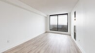 Located at 300 Antibes Dr in North York, Toronto, this well-appointed 3-bedroom, 2-bathroom unit offers a thoughtfully designed layout across a single floor. Light wood laminate flooring runs throughout, complementing crisp white walls and creating a clean, modern aesthetic.

The kitchen is a standout feature, showcasing white shaker-style cabinetry extending to the ceiling, a classic white subway tile backsplash, dark countertops, and a full suite of stainless steel appliances including a refrigerator, range, over-the-range microwave, and dishwasher. A breakfast bar peninsula provides additional counter space and casual dining options.

The open-concept living and dining area is bright and spacious, with large floor-to-ceiling sliding glass doors opening onto a private balcony that offers sweeping city views. The three bedrooms are well-sized, with the primary bedroom benefiting from generous natural light through a large window framing additional city views.

Both bathrooms are finished in a contemporary style. The main bathroom features white subway tile surrounding a soaker tub and shower combination, paired with a white vanity, large mirror, and modern light fixture. The second bathroom echoes this clean aesthetic with a white countertop vanity and elegant chrome fixtures. Two closets and a hallway complete this well-organized, move-in-ready home.
