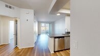 This 670-square-foot, one-bedroom, one-bathroom apartment is located at 13603 Marina Pointe Dr., Unit D310, in Marina Del Rey, CA. The unit is thoughtfully designed with an open-concept layout, featuring warm hardwood-style flooring throughout. The kitchen seamlessly opens to the living room via a peninsula with dark quartz countertops, offering additional prep and seating space. The kitchen is equipped with modern stainless steel appliances, including a gas range, microwave, and refrigerator, complemented by sleek, two-tone cabinetry and recessed lighting. The open living area is bright and spacious, providing a clean, neutral canvas with crisp white walls. The 150-square-foot primary bedroom includes a sliding glass door leading to a private balcony, where outdoor views of the Marina Del Rey surroundings can be enjoyed. The full bathroom features a tub/shower combo with white tile surround, a vanity with storage, and hardwood-style flooring. A hallway connects the main living areas to the bedroom and bathroom, optimizing the unit's functional flow. The balcony, accessed from the bedroom, offers an open-air retreat with a metal railing.