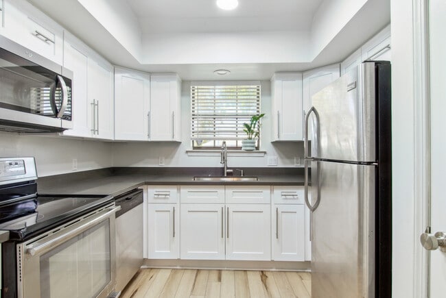 Fully renovated kitchen with brand new shaker cabinets, quartz countertops and stainless steel. - 4502 Park Dr N