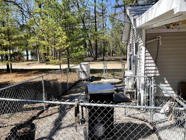 Small backyard with rear entrance door - 1129 N Sand Lake Rd
