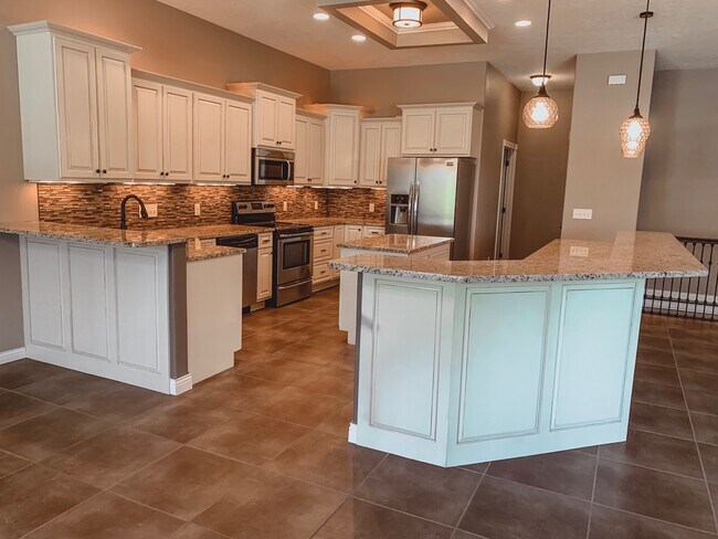 Open concept kitchen, dining, and living area - 2731 Castles Gate Dr