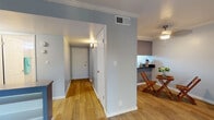 Located at 3750 Tamayo St in Fremont, California, this single-floor residence offers a thoughtfully designed layout with a cohesive color palette of soft blue-gray walls and crisp white trim throughout. Crown molding adds a refined architectural touch to the main living areas.

The open living area is a standout feature, showcasing warm hardwood-style flooring, large sliding glass doors that open onto a private balcony, and generous natural light with pleasant views of the surrounding greenery. The space flows seamlessly into a dedicated dining area with a built-in counter nook, ideal for casual meals or a workspace.

The kitchen is efficiently designed with white shaker-style cabinetry, sleek dark countertops that extend into a breakfast bar, stainless steel appliances, and a window above the sink that brings in additional natural light. The layout connects well to the main living and dining areas.

The bedroom features plush carpeting, crown molding, a window with outdoor views, and a clean, neutral palette that creates a calm retreat. The bathroom is well-appointed with a tub-shower combination, a dark-topped vanity with ample storage, wood-style flooring, and a small window for ventilation and light.

A welcoming entryway hallway with wood-style flooring connects all areas of the home, completing this comfortable and well-maintained residence in Fremont.
