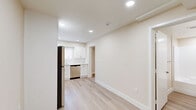 Located at 1147 W Linden St in Riverside, California, this thoughtfully designed one-bedroom, one-bathroom unit offers a clean, modern aesthetic across a single floor. Light wood-style flooring flows seamlessly throughout every room, creating a cohesive and airy atmosphere complemented by warm neutral wall tones and crisp white trim.

The kitchen is a standout feature, outfitted with white shaker-style cabinetry, white quartz countertops, and a full suite of stainless steel appliances including a refrigerator, electric range, built-in microwave, and dishwasher. Recessed lighting and a window above the sink bring in natural light, making the space feel bright and functional.

The main living area connects directly to the kitchen and is enhanced by a ceiling fan and a window offering views of the surrounding area. The bedroom is a well-proportioned private retreat, featuring a ceiling fan and a sliding-door closet for convenient storage.

The bathroom is cleanly finished with light wood-style flooring, a white vanity with brushed nickel hardware, a tiled tub-shower combo, and recessed lighting, offering a calm and practical space.

Overall, this unit presents a fresh, move-in-ready environment with consistent modern finishes that maximize both comfort and functionality.