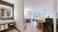 Located at 569 Lexington Avenue in Midtown Manhattan, this double occupancy room offers a well-organized and efficiently designed living space for two occupants. The main room accommodates two loft-style beds with built-in under-bed storage — a practical solution for maximizing space — along with light wood flooring that lends a clean, contemporary feel throughout. A dedicated desk and chair area is positioned against a geometric-patterned accent wall, providing a functional workspace. Natural light enters through a large window offering city views, keeping the room bright and airy. A compact refrigerator and microwave are also included, adding everyday convenience. The bathroom is thoughtfully appointed with large-format tile flooring, an open-frame vanity with a backlit mirror, and a separate water closet. A geometric-patterned wall divides the bathroom area from the main living space, adding a modern design touch while maintaining a sense of separation. The closet provides dedicated storage to help keep the space organized. The overall aesthetic is clean and modern, with a neutral white and light grey palette that creates a calm, livable environment well-suited for daily life in the heart of New York City.