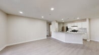 Located at 2423 Martin Luther King Dr in Atlanta, GA, this well-appointed 3-bedroom, 2-bathroom unit offers a thoughtfully designed single-level layout. The open-concept living and kitchen area serves as the heart of the home, featuring light wood-style flooring, recessed lighting, and a sliding glass door that invites natural light into the space. The kitchen is outfitted with crisp white shaker cabinetry, a subway tile backsplash, granite countertops, a large peninsula with an undermount sink, and stainless steel appliances including a refrigerator and electric range. The living area provides generous room for flexible furniture arrangements. All three bedrooms feature plush carpeting and neutral wall tones, with the secondary bedrooms offering corner windows that bring in additional natural light. Four closets are distributed throughout the unit, providing ample storage. The two full bathrooms are finished with white tile tub-shower combinations, brushed nickel fixtures, and granite-topped vanities. A central hallway connects the bedrooms to the main living spaces, creating a functional and organized floor plan. The overall aesthetic is clean, modern, and move-in ready.