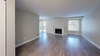 Located at 2519 S Meridian in Puyallup, WA, this 2-bedroom, 1-bathroom unit offers a well-organized, single-floor layout designed for comfortable everyday living. The living room is a standout space, featuring wood-style flooring, a classic fireplace with a white mantel, large windows that invite natural light, and sliding glass doors that open to a private balcony with outdoor views. The kitchen is efficiently designed with white shaker cabinetry, granite-style countertops, stainless steel refrigerator and range, a peninsula with a double sink, and a dedicated open pantry for additional storage. Both bedrooms are carpeted and finished with neutral tones, offering a quiet retreat. The primary bedroom includes a sliding-door closet and direct access to the full bathroom. The second bedroom features a window with outdoor views and a baseboard heater. The bathroom is well-appointed with a granite-topped vanity, white cabinetry, and a full tub-shower combination with tile surround and safety grab bar. Wood-style flooring carries throughout the main living areas, tying the space together with a clean, cohesive aesthetic.