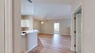 Located at 98 Waterside Drive in Wildwood, MO, this single-floor, 3-bedroom, 3-bathroom home offers a thoughtfully organized layout with clean, neutral finishes throughout. The open-concept living room features light hardwood-style flooring, a ceiling fan, and a striking green marble fireplace with a white mantle, adding a classic focal point to the space. Large sliding glass doors lead to a private balcony, allowing natural light to fill the room and providing outdoor views. The adjacent kitchen is equipped with white cabinetry, stainless steel appliances including a refrigerator, gas range, and microwave, recessed lighting, and a wraparound breakfast bar that opens to the living area. The generously sized primary bedroom includes a walk-in closet outfitted with wire shelving systems for organized storage. The additional bedrooms feature plush carpeting, window blinds for natural light control, and sliding double-panel closets. All three bathrooms are finished with light hardwood-style flooring, tub-shower combinations, and medicine cabinet mirrors. A dedicated laundry room with full-size washer and dryer and wire wall shelving adds everyday convenience. The home presents a clean, functional design suited for comfortable single-floor living.