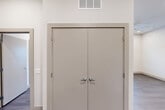 This well-designed two-bedroom, two-bathroom unit at 7520 Avenue C in Houston, Texas offers a clean, modern aesthetic across a thoughtfully laid-out single floor. The kitchen is outfitted with light wood-toned cabinetry, white subway tile backsplash, granite-look countertops, and stainless steel appliances including a full-size refrigerator and dishwasher — providing both style and functionality. Wood-look plank flooring runs throughout the entire unit, lending a cohesive and contemporary feel to every room. Both bedrooms are bright and well-proportioned, featuring large windows with blinds that invite natural light and offer views of the surrounding neighborhood. One bedroom is equipped with a ceiling fan for added comfort. The primary bedroom is complemented by a dedicated walk-in closet with multiple shelving rods and a built-in bench shelf, offering generous storage. The two bathrooms are finished with granite-topped vanities and wood-toned cabinetry; one includes a tub-shower combination with white tile surround, while the other features a tiled shower. The overall palette — neutral walls, warm flooring, and clean white trim — creates a bright and inviting atmosphere throughout this move-in-ready Houston residence.