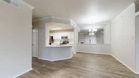 Located at 6243 Love Dr in Irving, TX, this single-story, 3-bedroom, 2-bathroom home offers a well-designed layout with a cohesive blend of comfort and functionality. The open-concept living room is accented by crown molding, a ceiling fan, a classic fireplace, and a large sliding glass door with vertical blinds that flood the space with natural light. Hardwood-style flooring runs throughout the main living areas, adding warmth and continuity.

The kitchen is a standout feature, showcasing white cabinetry, light countertops, a peninsula with a built-in sink, and a full suite of stainless steel appliances including a range, microwave, dishwasher, and refrigerator. A pass-through opening connects the kitchen to a dedicated dining area, enhanced by an elegant chandelier.

The three bedrooms are carpeted and bathed in natural light through large windows offering pleasant outdoor views. The primary bedroom is generously sized and includes access to a walk-in closet with wire shelving. The two bathrooms are finished in a clean, neutral palette, with one featuring a tiled soaking tub and shower combination. Two hallways provide efficient circulation throughout the home, completing this well-appointed Irving residence.