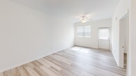 Located at 609 Grove Cir in Milton, Delaware, this well-appointed two-bedroom, two-bathroom home offers comfortable single-floor living with a clean, modern aesthetic. Light hardwood-style flooring flows throughout the entire home, complementing the bright white walls and creating a cohesive, airy atmosphere.

The kitchen serves as a standout feature, boasting rich dark-stained cabinetry, granite countertops, and a full suite of stainless steel appliances including a refrigerator, range, and built-in microwave. A peninsula with pendant lighting provides additional counter space and casual seating, opening seamlessly toward the living area.

Both bedrooms are well-sized, filled with natural light from windows fitted with blinds, and each equipped with ceiling fans. The primary bedroom offers a generous footprint with its own dedicated bathroom featuring a walk-in glass-door shower, dark wood vanity, and granite countertop. The second bathroom includes a tub-shower combination and matching granite vanity cabinetry.

A dedicated laundry room houses a full-size top-loading washer and dryer with additional shelving. The home also includes two closets for ample storage. A covered pergola visible from the exterior adds outdoor living potential to this move-in-ready Milton residence.