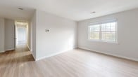 Located at 1009 Warwick Dr. in Aberdeen, Maryland, this single-floor home presents a clean, move-in-ready interior defined by a bright, neutral palette and thoughtful layout. The floor plan reveals a clear separation between living and sleeping areas, with a logical flow connecting each space.

The main living areas feature light-toned hardwood flooring that reflects natural light and contributes to an airy, open atmosphere. Crisp white walls and clean trim work are consistent throughout, lending the home a fresh, well-maintained appearance. Windows positioned on multiple walls allow natural light to reach deep into each room, with views of surrounding greenery visible from several vantage points.

The carpeted rooms offer a softer, quieter environment well-suited for bedrooms. These spaces are generously proportioned, with windows providing outdoor views and a warm, comfortable ambiance. Closets with built-in rods offer practical storage, and panel-style doors add a classic detail throughout.

Additional rooms featuring the light hardwood flooring provide versatile spaces that could serve a variety of functions. The home's consistent finishes, balanced layout, and abundant natural light create a cohesive and welcoming living environment throughout.