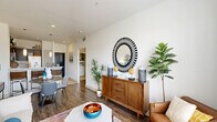 Located at 2222 Smith St in Houston, TX, this thoughtfully designed one-bedroom, one-bathroom residence offers a smart, efficient layout across a single floor. The entrance opens into a bright, open-concept living and dining area featuring rich wood-look flooring, crisp white walls, and large windows that invite an abundance of natural light. The living room provides a welcoming, airy atmosphere with ample space for comfortable seating arrangements.

The kitchen is a standout feature, showcasing dark espresso cabinetry, white quartz countertops, a classic subway tile backsplash, and a full suite of stainless steel appliances including a refrigerator, range, microwave, and dishwasher. A peninsula with pendant lighting and bar seating connects the kitchen to the dining area, creating an ideal space for casual dining and entertaining.

The bedroom offers a serene retreat with plush carpet flooring, a ceiling fan, a generous window with outdoor views, and access to multiple closets for ample storage. The full bathroom features tile flooring, a dark-cabinet vanity with a white countertop, a tub-shower combination, and louvered closet doors. Additional practical spaces include a dedicated laundry area, a pantry, and two hallways that improve flow throughout the residence.