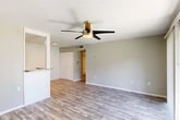 Located at 7200 Powers Ave in Jacksonville, FL, this single-floor, 2-bedroom, 2-bathroom home offers a well-organized layout designed for comfortable everyday living. Wood-look laminate flooring flows consistently throughout, complemented by neutral gray walls and textured ceilings that give each room a clean, cohesive aesthetic.

The open-plan living, dining, and kitchen area forms the heart of the home. The living space is bright and airy, featuring a ceiling fan with light fixture and a sliding glass door fitted with vertical blinds that opens to a private patio overlooking a grassy outdoor area. The galley-style kitchen is efficiently designed with white cabinetry, granite-look countertops, subway tile backsplash, and stainless steel appliances including a range, microwave, refrigerator, and dishwasher. A breakfast bar counter connects the kitchen to the living and dining area.

Both bedrooms are generously proportioned, with the spacious primary bedroom offering a large closet and ample room to furnish comfortably. The second bedroom features a window with blinds that brings in natural light. Each bedroom is served by its own full bathroom, both featuring tiled tub-shower combinations with brushed nickel hardware and clean white finishes. Additional storage is provided by five closets throughout the home, including a hallway connecting the private sleeping quarters.
