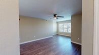 Located at 301 N Gross Rd in Kingsland, Georgia, this single-floor, two-bedroom, two-bathroom home offers a well-organized and functional layout. The open-concept living, dining, and kitchen area serves as the heart of the home, featuring dark hardwood-style flooring, neutral beige walls, a textured ceiling, and a ceiling fan with light. A large window allows natural light to fill the living space, creating a bright and welcoming atmosphere.

The kitchen is equipped with warm oak cabinetry, white countertops, a white electric range, and a full-size refrigerator, providing ample storage and prep space. Both bedrooms are carpeted for comfort and include ceiling fans. The primary bedroom is a generous size with access to a closet and natural light from a window. The second bedroom also offers good proportions with its own closet access.

The two bathrooms are clean and functional, each featuring a tub-shower combination. A dedicated laundry room includes washer and dryer hookups — both water and electric — along with overhead wire shelving. Four closets throughout the home provide excellent storage capacity. A utility room and hallway complete the practical and efficient floor plan of this Kingsland residence.