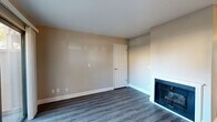 Located at 7190 Calvine Rd in Sacramento, CA, this two-bedroom, three-bathroom single-floor residence offers a thoughtfully arranged layout across a comfortable footprint. The living room serves as the heart of the home, featuring wood-look laminate flooring, warm neutral-toned walls, and a classic fireplace with a white surround — creating an inviting, cozy atmosphere. A ceiling fan adds both comfort and style to the space.

The combined dining and kitchen area is well-appointed with dark cabinetry, granite-look countertops, and white appliances including a range, dishwasher, and refrigerator. A window above the sink brings in natural light, making the kitchen feel bright and functional. A pantry provides additional storage convenience.

Both bedrooms are carpeted and feature sliding double-door closets. The primary bedroom includes its own dedicated closet space, while a window in the secondary bedroom offers pleasant outdoor views. Each of the three bathrooms is finished with wood-look flooring, dark vanity cabinetry with granite-style countertops, and glass-enclosed shower/tub combinations.

A hallway connects the main living areas to the bedrooms, and a private patio extends the living space outdoors. The overall design is clean, neutral, and move-in ready.