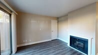 Located at 7190 Calvine Rd in Sacramento, CA, this two-bedroom, three-bathroom single-floor residence offers a thoughtfully arranged layout across a comfortable footprint. The living room serves as the heart of the home, featuring wood-look laminate flooring, warm neutral-toned walls, and a classic fireplace with a white surround — creating an inviting, cozy atmosphere. A ceiling fan adds both comfort and style to the space.

The combined dining and kitchen area is well-appointed with dark cabinetry, granite-look countertops, and white appliances including a range, dishwasher, and refrigerator. A window above the sink brings in natural light, making the kitchen feel bright and functional. A pantry provides additional storage convenience.

Both bedrooms are carpeted and feature sliding double-door closets. The primary bedroom includes its own dedicated closet space, while a window in the secondary bedroom offers pleasant outdoor views. Each of the three bathrooms is finished with wood-look flooring, dark vanity cabinetry with granite-style countertops, and glass-enclosed shower/tub combinations.

A hallway connects the main living areas to the bedrooms, and a private patio extends the living space outdoors. The overall design is clean, neutral, and move-in ready.