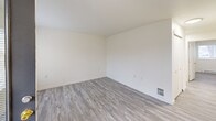 Located at 1590 NE Northwood Dr in Pullman, WA, this single-floor, 3-bedroom, 2-bathroom unit offers a clean, modern aesthetic throughout. Light-toned luxury vinyl plank flooring runs seamlessly across the entire unit, complementing the bright white walls and creating a cohesive, contemporary feel.

The open-concept layout brings together the living room, dining area, and kitchen into one shared space, maximizing functionality. The kitchen features white cabinetry, a full-size refrigerator, and an electric range, all illuminated by overhead fluorescent lighting. A hallway connects the main living area to the private bedroom wing.

Each of the three bedrooms is well-proportioned and filled with natural light from windows with blinds. The primary bedroom includes a sliding-door closet, offering convenient storage. The additional bedrooms also feature sliding closets and baseboard heating units. In total, four closets are distributed throughout the unit.

The two bathrooms are cleanly finished, each equipped with a tub-shower combination, a single-sink vanity with a mirror, and LVP flooring. An in-unit laundry area adds everyday convenience. A private patio extends the living space outdoors. The overall ambiance is bright, clean, and move-in ready, suited for comfortable everyday living.
