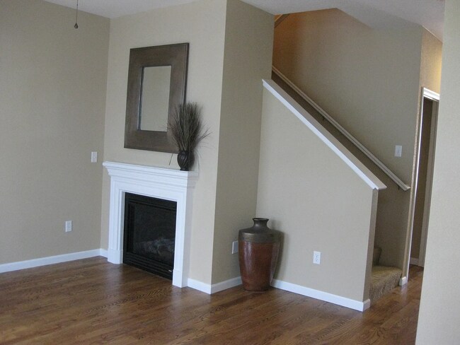 Living room area with gas fireplace - 10257 E 31st Ave