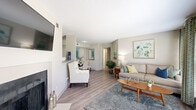 Located at 10190 Allisonville Rd in Fishers, Indiana, this single-floor, 2-bedroom, 2-bathroom residence offers a thoughtfully designed layout with comfortable living spaces throughout. The open living room is a welcoming centerpiece, featuring wood-style flooring, a fireplace, and large sliding glass doors that flood the room with natural light and provide access to an outdoor patio area. The adjoining dining area transitions seamlessly into a well-equipped kitchen, which boasts dark espresso cabinetry, granite-style countertops, stainless steel appliances, and a pantry closet for added storage. The generously sized primary bedroom features plush carpeting, a ceiling fan, a walk-in closet, and a private en-suite bathroom. The second bedroom is equally comfortable, also with carpeting and ceiling fan. Both bathrooms are clean and functional, with the second bath featuring a tiled tub-shower combination and granite-topped vanity. A dedicated in-unit laundry room with a full-size washer and dryer adds everyday convenience. Two closets provide ample storage throughout the home. The neutral color palette and consistent finishes create a cohesive, modern ambiance suited for comfortable everyday living.