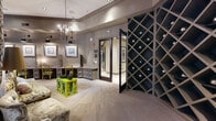 Located in Houston's vibrant Montrose neighborhood, this single-floor amenity center at 4310 Dunlavy St offers a refined and well-appointed experience across a generously sized layout. The space is divided into distinct functional areas, each thoughtfully designed with upscale finishes and cohesive décor.

The expansive fitness center is a standout feature, offering an extensive selection of strength-training machines, free weights, benches, treadmills, ellipticals, stationary bikes, and a spin cycle. Patterned carpet flooring, large framed wall art, floor-to-ceiling mirrors, and bold gold pendant lighting lend the gym a polished, boutique aesthetic. Natural light streams in through large windows, and a ceiling fan adds comfort during workouts.

Adjacent to the gym, a welcoming hallway connects to a sophisticated lounge area furnished with a floral sofa, vibrant accent tables, built-in workstations, and a crystal chandelier overhead — ideal for remote work or casual gatherings. Framed artwork lines the walls, adding a gallery-like ambiance.

A private conference room features a long wooden table, upholstered dining chairs, a crystal chandelier, decorative mirrors, and a large display screen, making it well-suited for meetings or private events. A dramatic diamond-pattern wine storage wall lines the connecting corridor, adding a luxurious architectural focal point throughout the transition spaces.