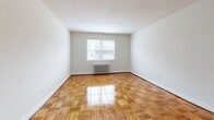 This well-designed 670 square foot apartment in Silver Spring, Maryland, offers a harmonious blend of functionality and style. The single-floor layout comprises a living room, bedroom, kitchen, bathroom, and hallway, creating an efficient use of space. The standout feature is the beautiful parquet flooring that runs throughout the apartment, adding warmth and character to each room.

The kitchen has been thoughtfully renovated, boasting white shaker-style cabinetry that provides ample storage. The upper and lower cabinets are complemented by a speckled granite countertop, creating a clean and modern aesthetic. A window above the sink allows natural light to flood the space, enhancing the bright and airy feel.

The living area and bedroom are generously sized, with the primary bedroom measuring 170 square feet. Both rooms feature large windows that not only provide natural illumination but also offer views of the surrounding area. The rooms are equipped with radiator heating, ensuring comfort during colder months.

The bathroom, while compact, is efficiently designed with clean white tiles from floor to ceiling and a bathtub-shower combination. The apartment's neutral color palette throughout allows for easy personalization to suit individual tastes.

This apartment at 2107 Belvedere Blvd combines practicality with classic charm, making it an ideal living space for those seeking a cozy yet stylish home in Silver Spring.