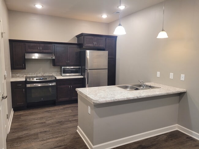 kitchen with stainless appliances - Aurora Estates