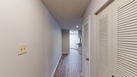Located at 125 Royal Dr in Madison, Alabama, this single-floor, 2-bedroom, 2-bathroom residence offers a practical and comfortable layout. The living room is a welcoming space featuring wood-look laminate flooring, neutral-toned walls, a textured ceiling, and a sliding glass door that opens to a private balcony with outdoor views, allowing natural light to fill the room. Adjacent to the living area, the galley-style kitchen is equipped with white cabinetry accented with wood trim, a white electric range, refrigerator, dishwasher, and ample counter space, with wood-look flooring carried throughout. Both bedrooms are carpeted and feature ceiling fans with light fixtures. The primary bedroom is a comfortable size with direct access to its own bathroom and a walk-in closet outfitted with wire shelving for organized storage. The second bedroom also features a window that brings in natural light. Each of the two full bathrooms includes a tub-shower combination, toilet, and a vanity with a single sink. Both bathrooms feature wood-look flooring and warm neutral tones. A second closet provides additional storage throughout the home. The textured ceilings are consistent throughout the residence, contributing to the overall cohesive design.