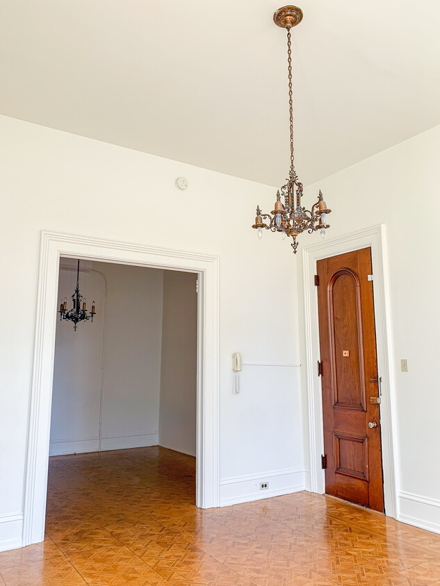 View of front door from inside building, standing in extra room, looking into potential living room - 325 N Duke St