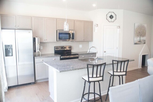 Building Photo - Introducing a one-year-old end unit townhome
