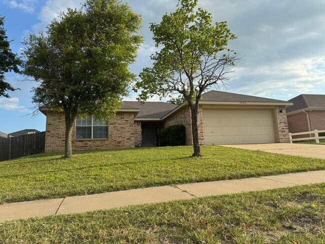 Corner-to-corner perspective showcases the generous lot size and side privacy fence. - 2806 Maria Dr