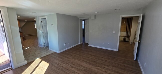 Living room, bathroom door on left, Bedroom 1 in the middle, Laundry on right - 103 S Main St