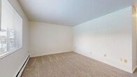 Located at 680 Riverview Dr in Columbus, Ohio, this two-bedroom, one-bathroom single-floor residence offers a straightforward and functional layout. The combined living and dining area serves as the heart of the home, featuring a blend of hardwood-style flooring and plush carpeting, along with multiple windows that bring in natural light and views of the surrounding neighborhood. Baseboard heating units are present throughout, ensuring consistent warmth across the space.

The kitchen is efficiently laid out and connects seamlessly to the living and dining area. A hallway leads to the two bedrooms, both finished with wall-to-wall carpet and neutral white walls. The primary bedroom offers a comfortable footprint, while the second bedroom provides a cozy and versatile space. Three closets are distributed throughout the unit, offering practical storage solutions; the bedroom closets feature sliding wood-panel doors with built-in hanging rods.

The bathroom is clean and utilitarian, equipped with a full-sized soaking tub and shower combination, a toilet, and wood-look vinyl flooring. Throughout the unit, the white walls and neutral finishes create a blank canvas well-suited for personalization. The overall layout is efficient and well-organized, making practical use of the available space.