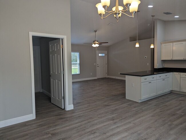 Building Photo - New 3/2/2 fenced home with Many Upgrades i...